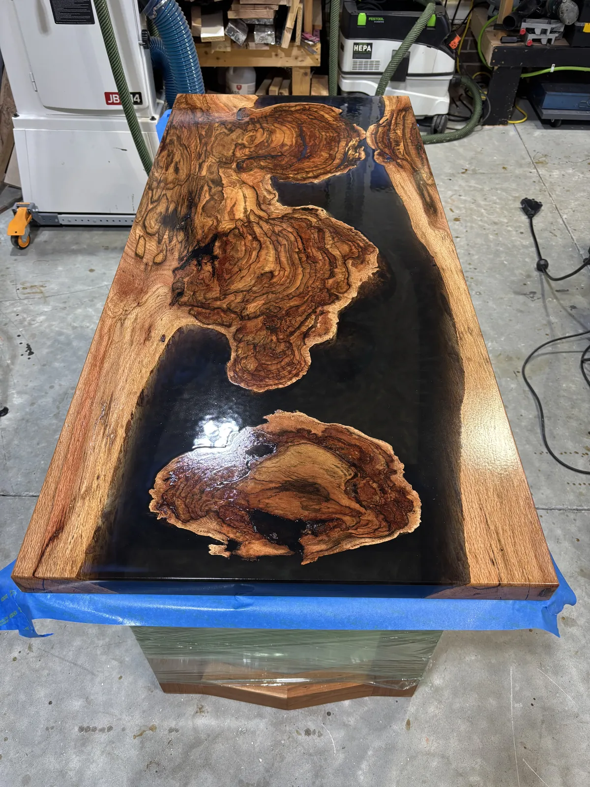 Burl and resin dining top, Figured slabs set in deep black resin