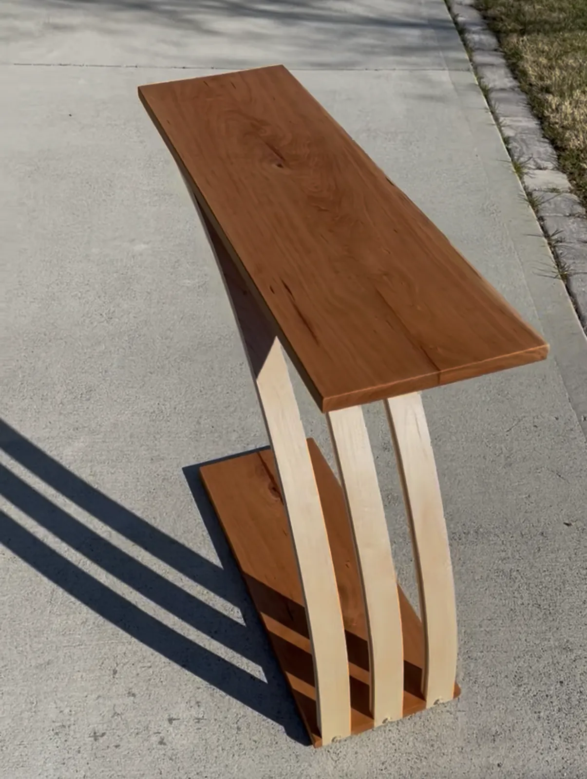 Cherry console table, Bent maple supports, cantilevered top
