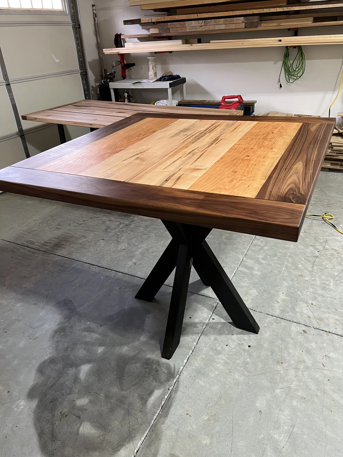 Pedestal dining table, Walnut, maple and cherry top, black spider base